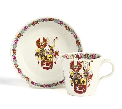 Lot 7 - A NYMPENBURG HAUSMALER ARMORIAL CUP AND SAUCER, CIRCA 1785
