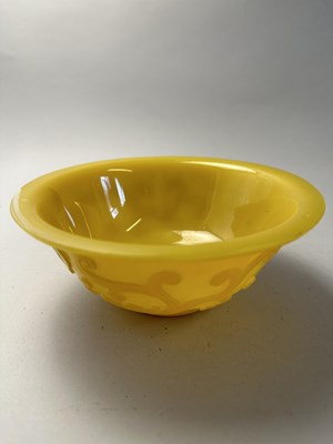 Lot 92 - A CHINESE EGG-YOLK YELLOW GLASS 'DRAGON' BOWL, QING DYNASTY, 19TH CENTURY