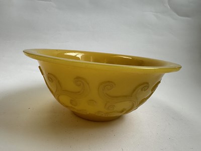 Lot 92 - A CHINESE EGG-YOLK YELLOW GLASS 'DRAGON' BOWL, QING DYNASTY, 19TH CENTURY