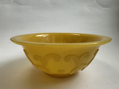 Lot 92 - A CHINESE EGG-YOLK YELLOW GLASS 'DRAGON' BOWL, QING DYNASTY, 19TH CENTURY