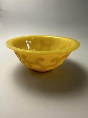 Lot 92 - A CHINESE EGG-YOLK YELLOW GLASS 'DRAGON' BOWL, QING DYNASTY, 19TH CENTURY