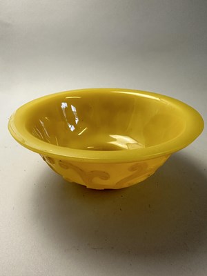 Lot 92 - A CHINESE EGG-YOLK YELLOW GLASS 'DRAGON' BOWL, QING DYNASTY, 19TH CENTURY