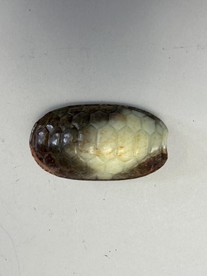 Lot 87 - A CHINESE CELADON AND RUSSET JADE TURTLE SHELL