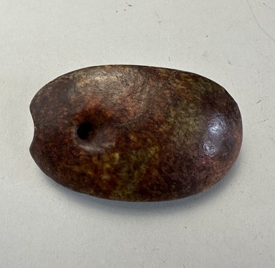 Lot 87 - A CHINESE CELADON AND RUSSET JADE TURTLE SHELL
