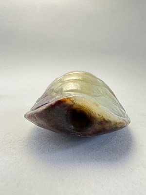 Lot 87 - A CHINESE CELADON AND RUSSET JADE TURTLE SHELL