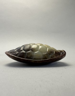 Lot 87 - A CHINESE CELADON AND RUSSET JADE TURTLE SHELL