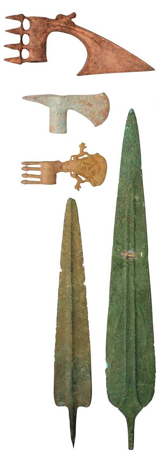 Lot 502 - A COPPER ALLOY SPEARHEAD, POSSIBLY LURISTAN CIRCA 1300-900 B.C., ANOTHER, LATER, AND THREE AXE HEADS, IN LURISTAN BRONZE AGE STYLE, 20TH CENTURY