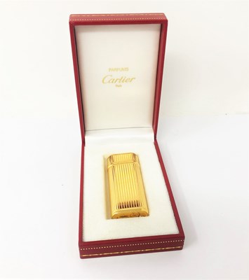 Lot 423 - A CARTIER GOLD PLATED LIGHTER^ LATE 20TH...
