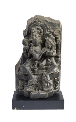 Lot 162 - A GREY STONE FRAGMENTARY STELE DEPICTING UMAMAHESVARA, PALA, EASTERN INDIA, CIRCA 11TH CENTURY