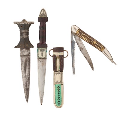 Lot 626 - AN INDO PERSIAN DAGGER, A TUAREG DAGGER AND A FOLDING FISH KNIFE