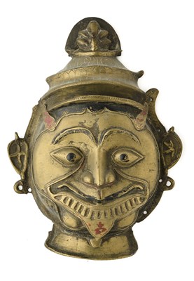 Lot 182 - A BRASS MASK OF KALI, DECCAN, SOUTHERN INDIA, 18TH/19TH CENTURY
