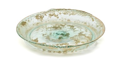 Lot 55 - A ROMAN GREEN GLASS SHALLOW DISH, CIRCA 2ND CENTURY A.D.