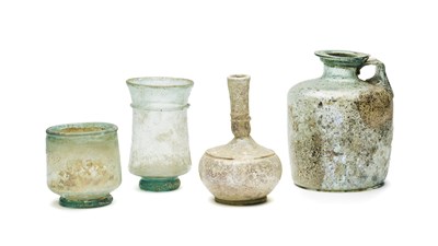 Lot 47 - FOUR ROMAN PALE GREEN GLASS VESSELS, CIRCA 1ST-4TH CENTURY A.D.