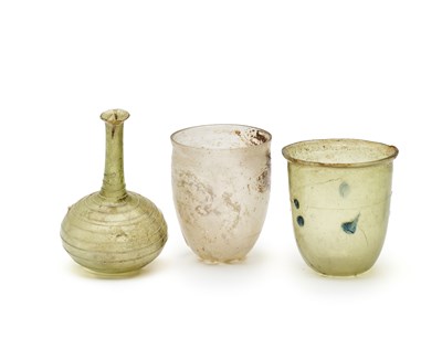 Lot 60 - THREE ROMAN GLASS VESSELS, CIRCA 1ST-4TH CENTURY A.D.