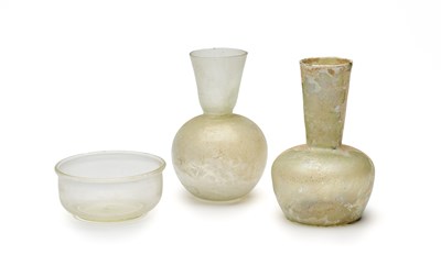 Lot 73 - THREE ROMAN PALE GLASS VESSELS, CIRCA 2ND-4TH CENTURY A.D.