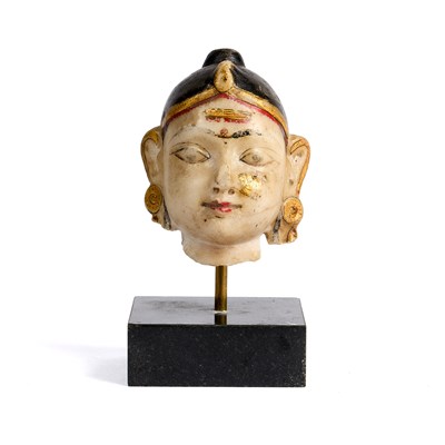Lot 509 - A SMALL PAINTED MARBLE HEAD OF A DEITY, RAJASTHAN, 19TH CENTURY