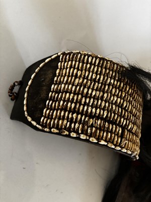 Lot 525 - AN AFRICAN (TUAREG) LEATHER BAG, AND A NAGA DAO HOLDER AND BELT, BOTH LATE 19TH/EARLY 20TH CENTURY