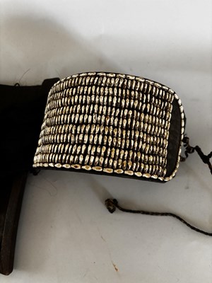 Lot 525 - AN AFRICAN (TUAREG) LEATHER BAG, AND A NAGA DAO HOLDER AND BELT, BOTH LATE 19TH/EARLY 20TH CENTURY