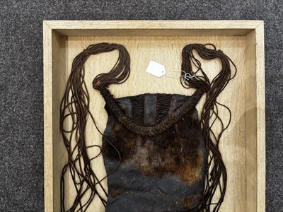 Lot 525 - AN AFRICAN (TUAREG) LEATHER BAG, AND A NAGA DAO HOLDER AND BELT, BOTH LATE 19TH/EARLY 20TH CENTURY