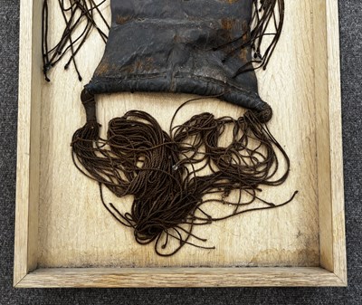 Lot 525 - AN AFRICAN (TUAREG) LEATHER BAG, AND A NAGA DAO HOLDER AND BELT, BOTH LATE 19TH/EARLY 20TH CENTURY
