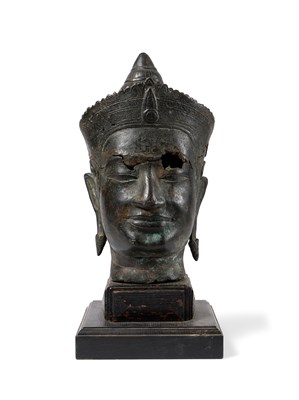 Lot 117 - A RARE NEAR-LIFESIZE KHMER FRAGMENTARY BRONZE HEADF OF A DEITY, CAMBODIA, 11TH/12TH CENTURY