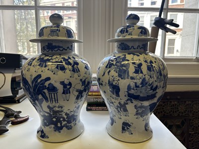 Lot 11 - A LARGE PAIR OF CHINESE BLUE AND WHITE 'HUNDRED BOYS' VASES AND COVERS, QING DYNASTY, 18TH CENTURY