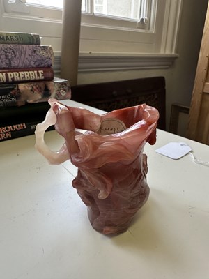 Lot 18 - A CHINESE ROSE AGATE 'LOTUS AND PEACH' LIBATION CUP, 20TH CENTURY