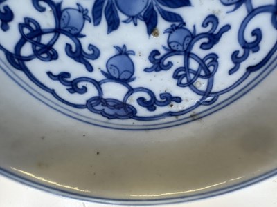 Lot 5 - A CHINESE BLUE AND WHITE PEACH AND POMEGRANATE SAUCER DISH, CHENGHUA MARK, KANGXI PERIOD (1662-1722)