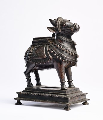 Lot 127 - A BRONZE FIGURE OF NANDI BULL, TAMIL NADU, SOUTH INDIA, CIRCA 18TH CENTURY