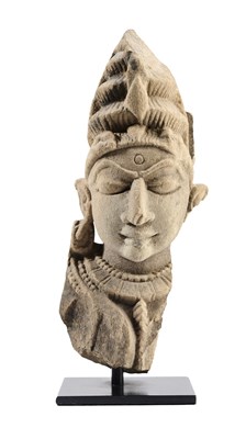 Lot 137 - A BUFF SANDSTONE HEAD OF A DEITY, CENTRAL INDIA, 11TH/12TH CENTURY