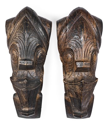 Lot 144 - A PAIR OF TOBA BATAK HEADS OF MYTHICAL BEASTS (SINGA), SUMATRA, EARLY 20TH CENTURY