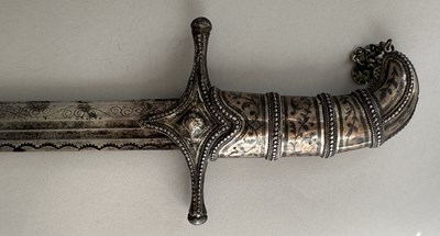 Lot 25 - A CAUCASIAN SWORD WITH NIELLOED SILVER MOUNTS, 19TH CENTURY